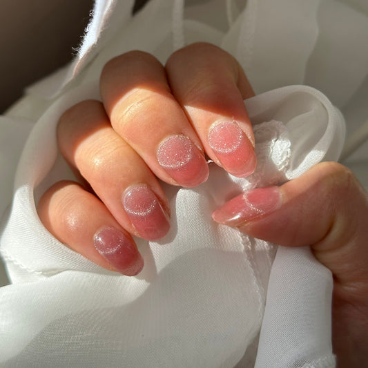 Close-up of a hand holding white fabric with a blurred background