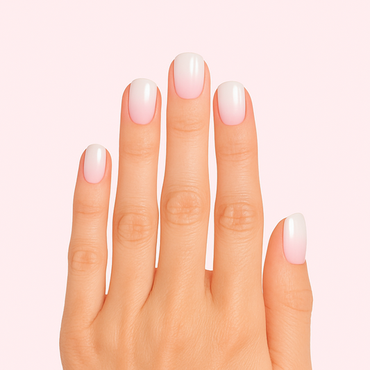 pink (base) to white (tip) gradient gel nails on light skinned hand
